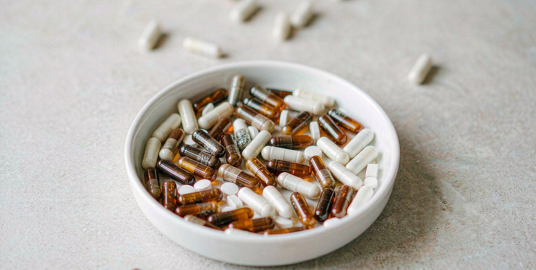 Flat lay of beef liver supplement capsules in a white dish on a light surface with soft daylight