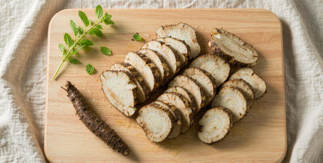 Fresh sliced burdock root on a light wooden board with mint, bright natural light