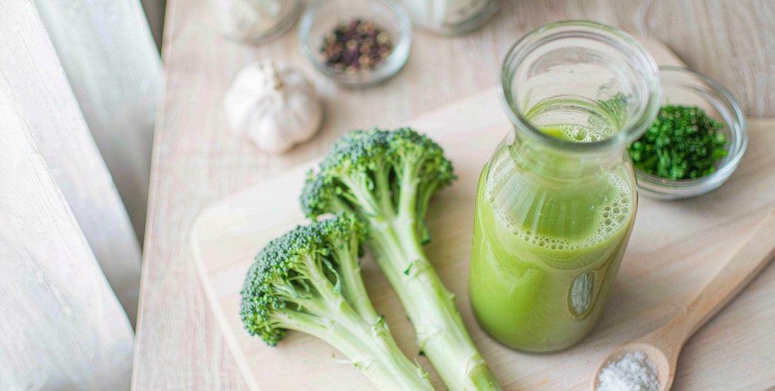 Liver support liquid drops with cruciferous vegetables on a clean bright board
