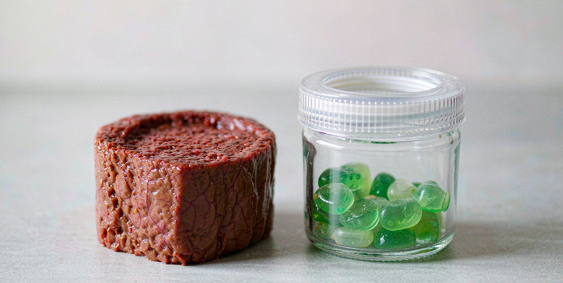 A beef liver cube beside a small jar of supplement gummies in soft natural light