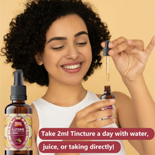 Dropper bottle of L-lysine liquid drops beside a folded hand towel and citrus slice